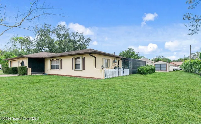 a front view of a house with yard and green space