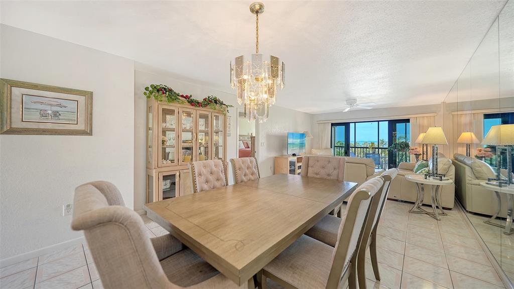 6234 Midnight Pass Road, Unit 307 Sarasota, FL 34242 - Photo 11 of 61 a dining room with furniture and window