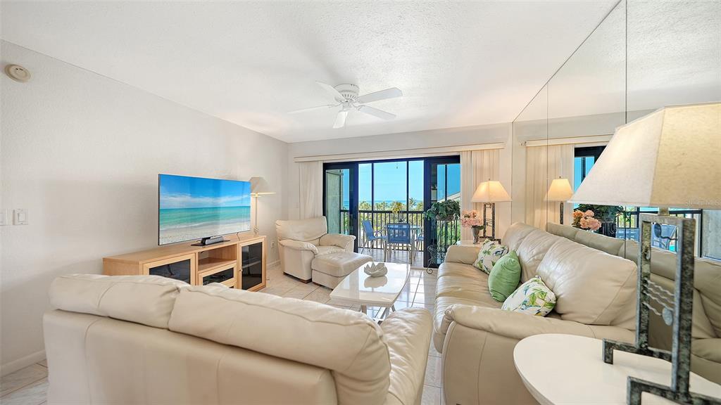 6234 Midnight Pass Road, Unit 307 Sarasota, FL 34242 - Photo 12 of 61 a living room with furniture and a large window