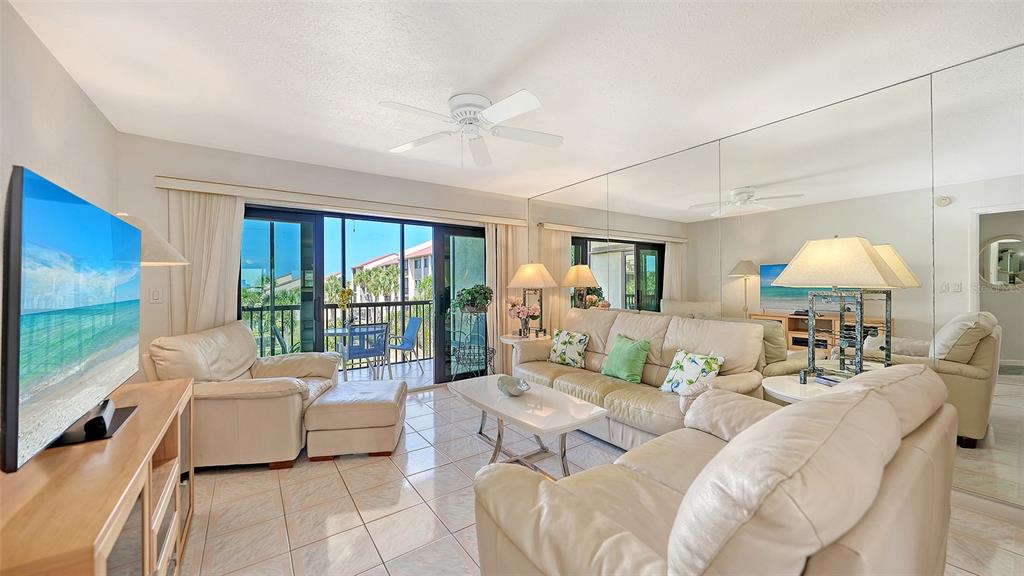 6234 Midnight Pass Road, Unit 307 Sarasota, FL 34242 - Photo 13 of 61 a living room with furniture and a large window