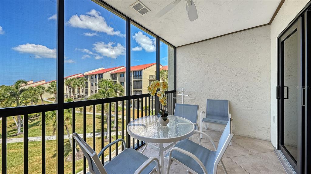 6234 Midnight Pass Road, Unit 307 Sarasota, FL 34242 - Photo 18 of 61 a view of a city from a balcony with furniture