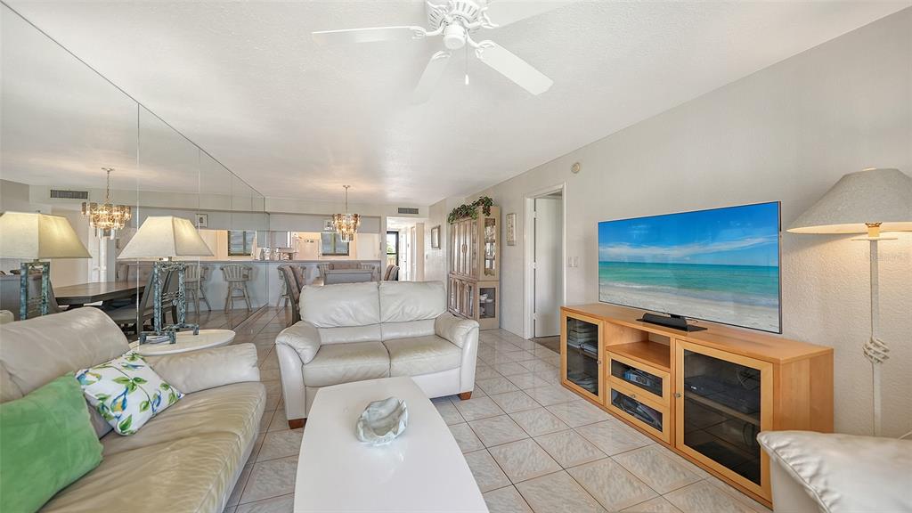 6234 Midnight Pass Road, Unit 307 Sarasota, FL 34242 - Photo 19 of 61 a living room with furniture and a flat screen tv