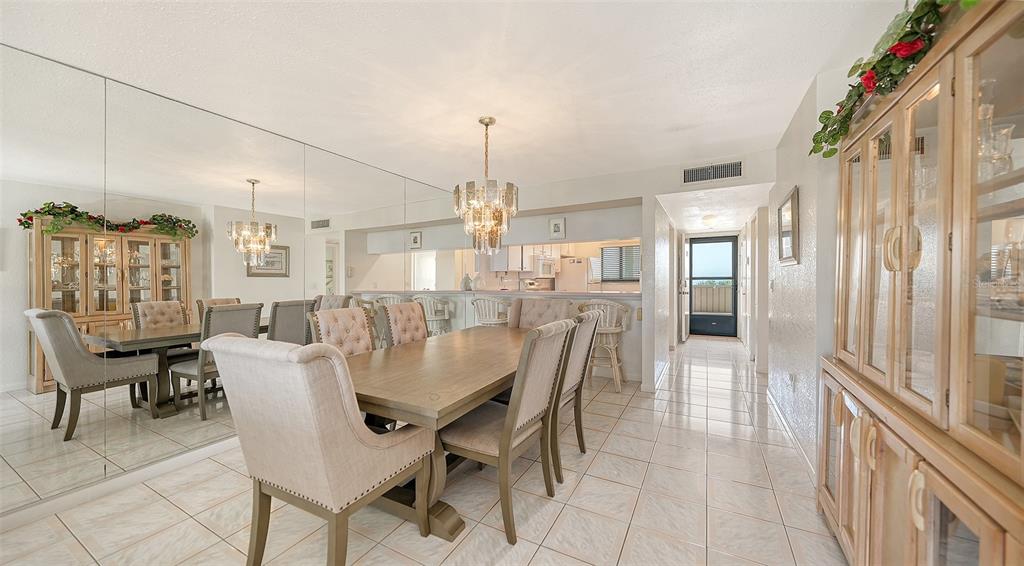 6234 Midnight Pass Road, Unit 307 Sarasota, FL 34242 - Photo 21 of 61 a dining room with furniture a chandelier and window