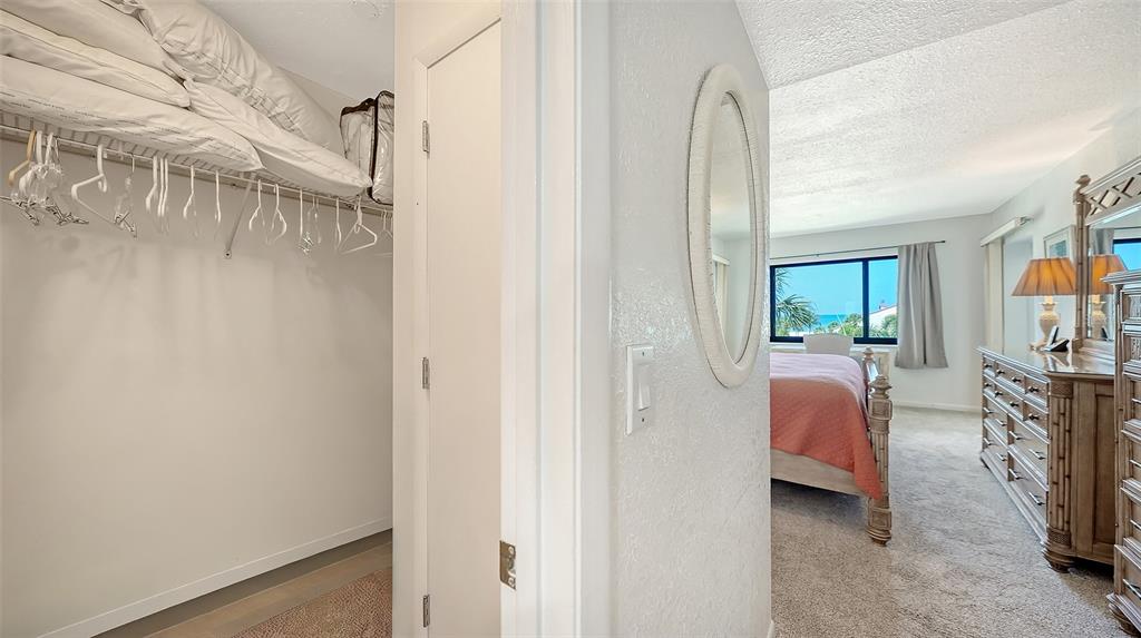 6234 Midnight Pass Road, Unit 307 Sarasota, FL 34242 - Photo 29 of 61 a en suite bathroom with a sink and a mirror