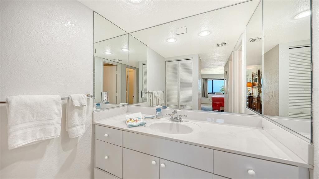 6234 Midnight Pass Road, Unit 307 Sarasota, FL 34242 - Photo 30 of 61 a bathroom with a sink and a mirror
