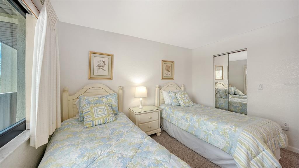 6234 Midnight Pass Road, Unit 307 Sarasota, FL 34242 - Photo 33 of 61 a bedroom with double bed and a painting