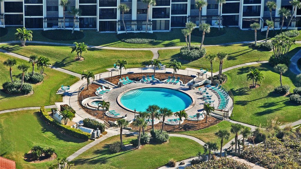 6234 Midnight Pass Road, Unit 307 Sarasota, FL 34242 - Photo 39 of 61 a view of a swimming pool with a patio and plants