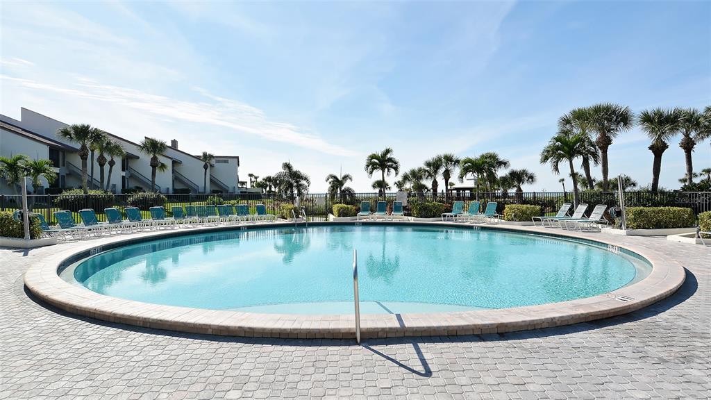 6234 Midnight Pass Road, Unit 307 Sarasota, FL 34242 - Photo 40 of 61 a view of a swimming pool with a lake