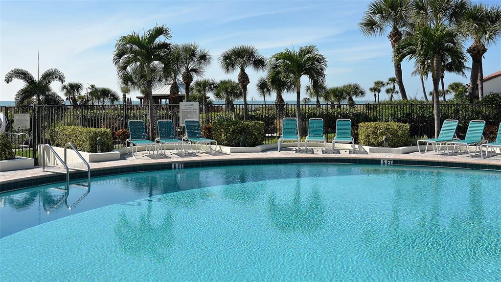 6234 Midnight Pass Road, Unit 307 Sarasota, FL 34242 - Photo 43 of 61 a view of a lake with boats and palm trees