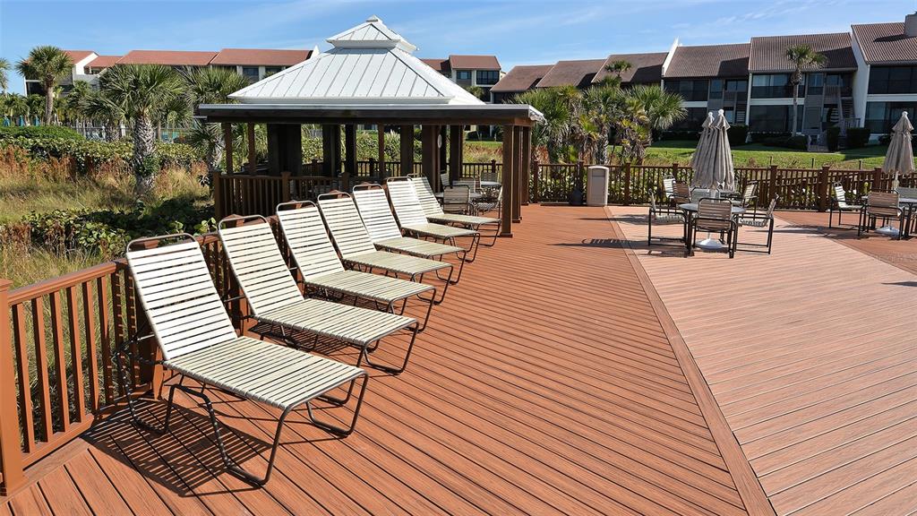 6234 Midnight Pass Road, Unit 307 Sarasota, FL 34242 - Photo 49 of 61 a view of a patio with a table and chairs