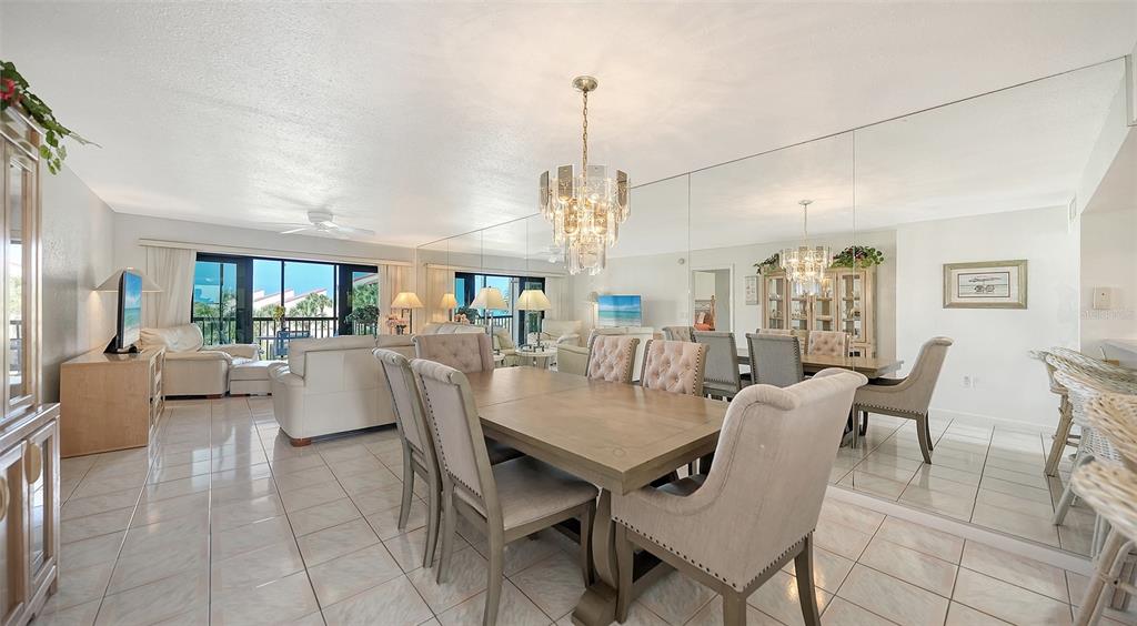 6234 Midnight Pass Road, Unit 307 Sarasota, FL 34242 - Photo 9 of 61 a view of a dining room and livingroom with furniture wooden floor a chandelier