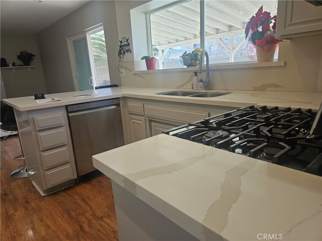 37323 Daybreak Street Palmdale, CA 93550 - Photo 12 of 58 a kitchen with a sink a stove and cabinets