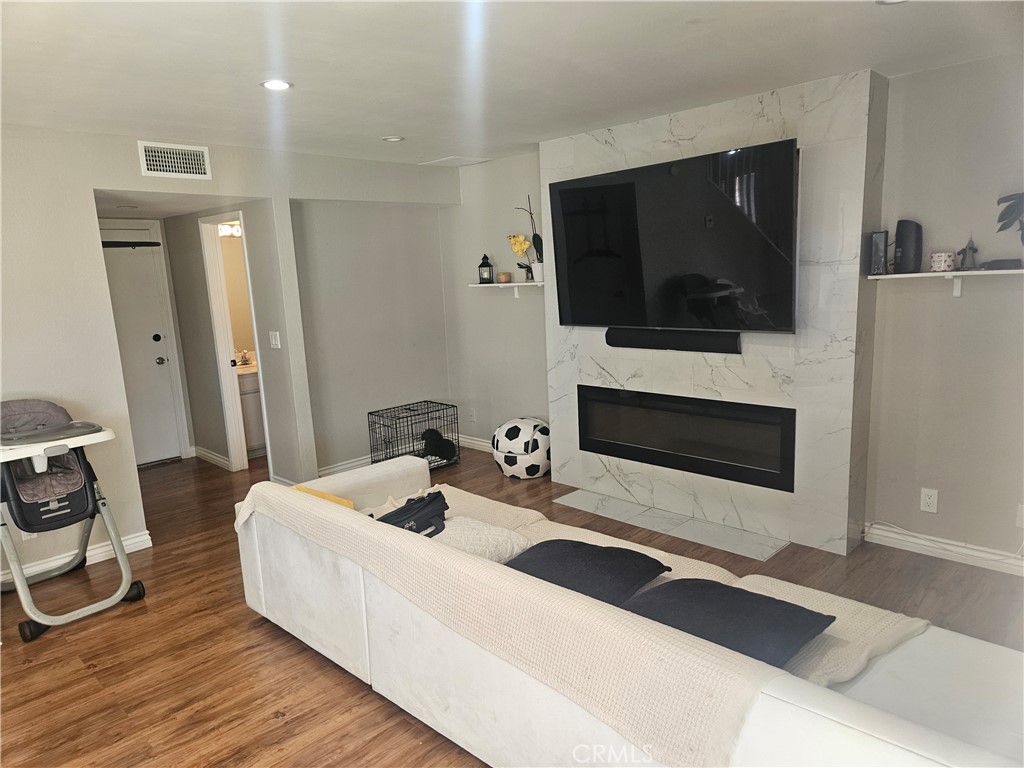 37323 Daybreak Street Palmdale, CA 93550 - Photo 17 of 58 a living room with furniture a flat screen tv and a fireplace