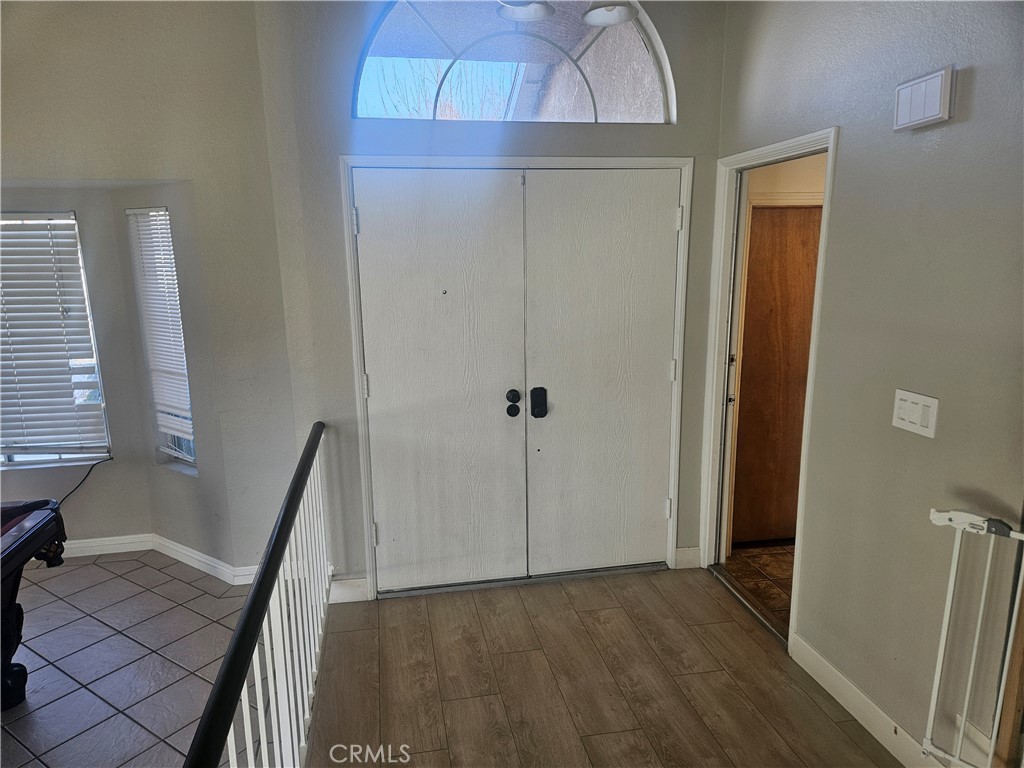 37323 Daybreak Street Palmdale, CA 93550 - Photo 31 of 58 a view of a hallway with wooden floor and staircase