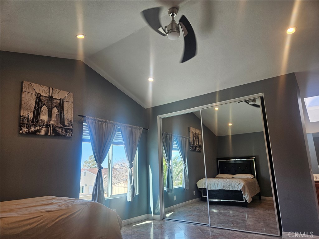 37323 Daybreak Street Palmdale, CA 93550 - Photo 34 of 58 a bedroom with a bed and glass door