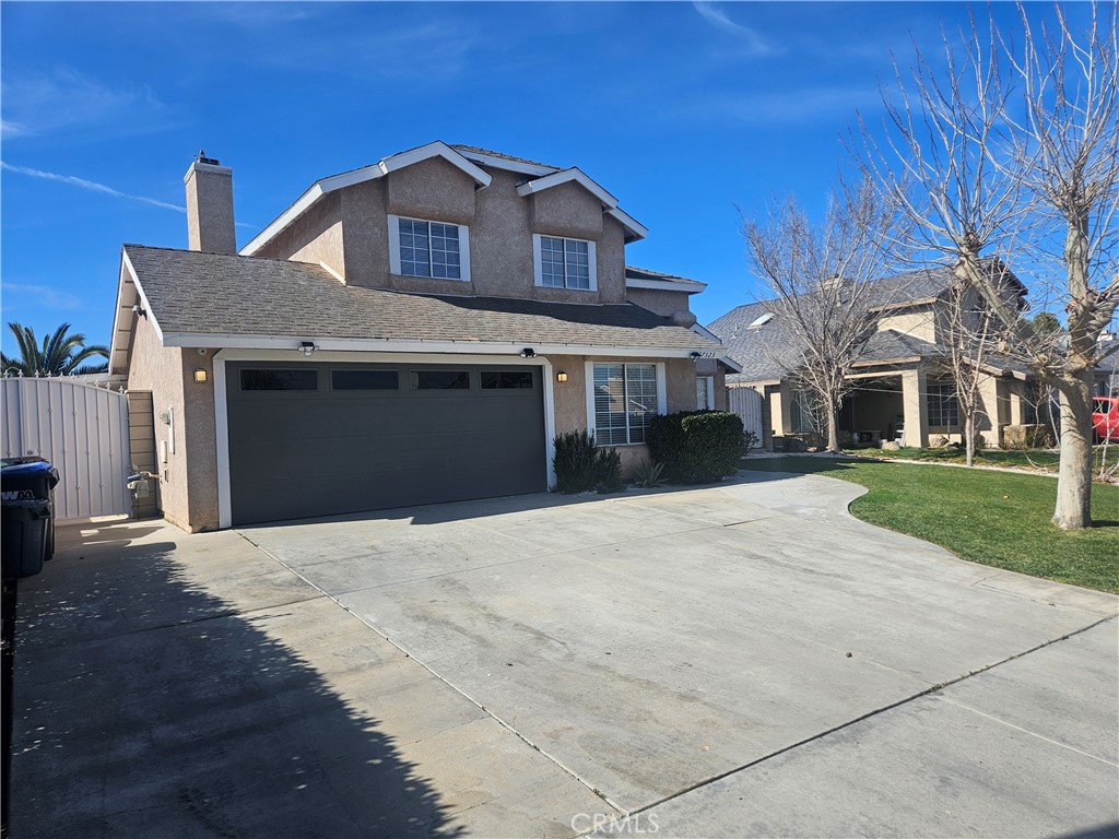 37323 Daybreak Street Palmdale, CA 93550 - Photo 5 of 58 a front view of a house with a yard