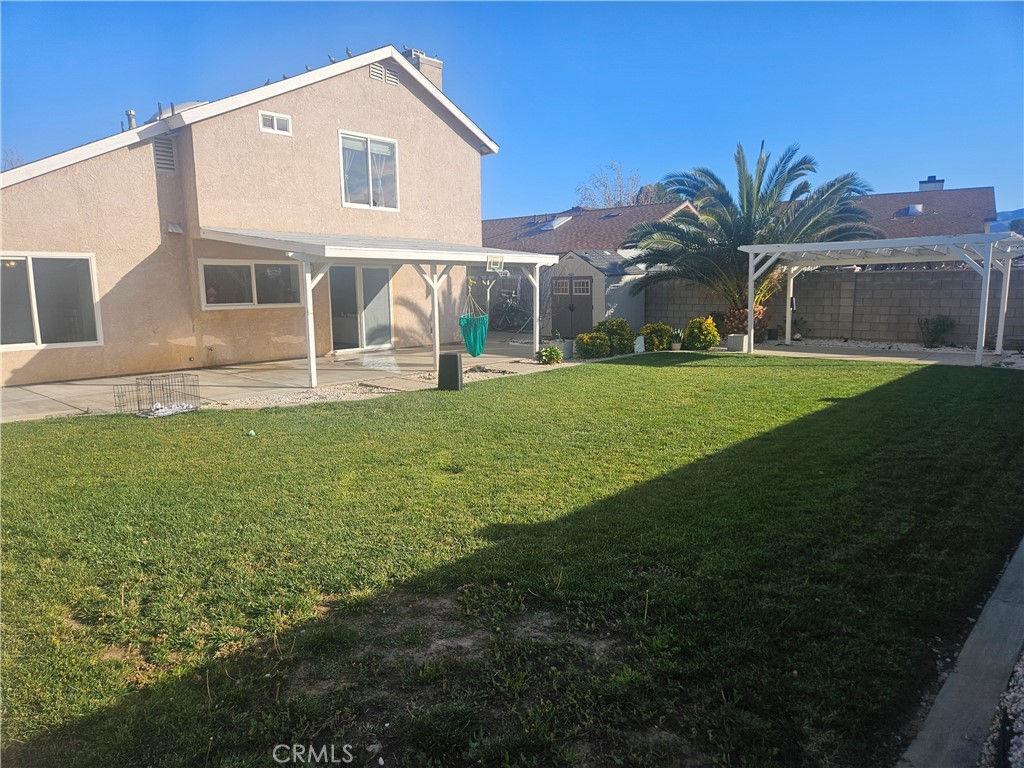 37323 Daybreak Street Palmdale, CA 93550 - Photo 56 of 58 a front view of a house with a yard and garage