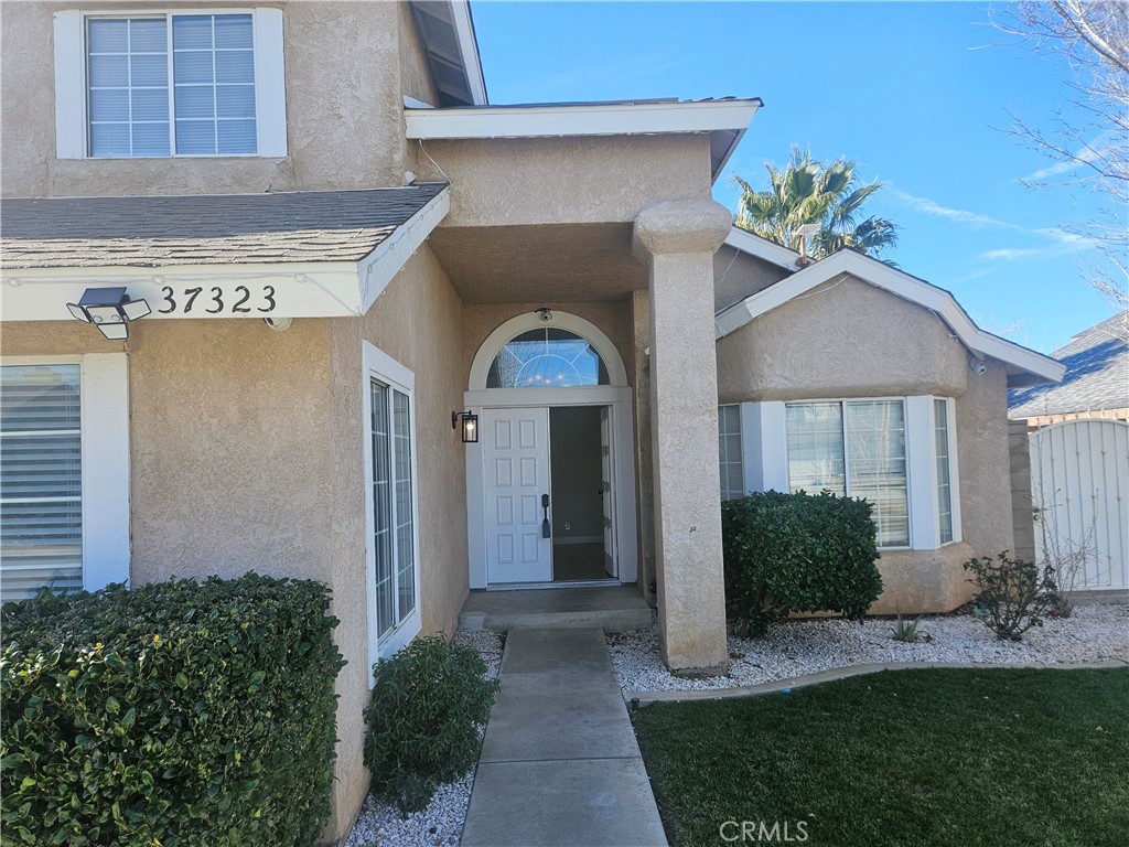 37323 Daybreak Street Palmdale, CA 93550 - Photo 6 of 58 a front view of a house with a yard