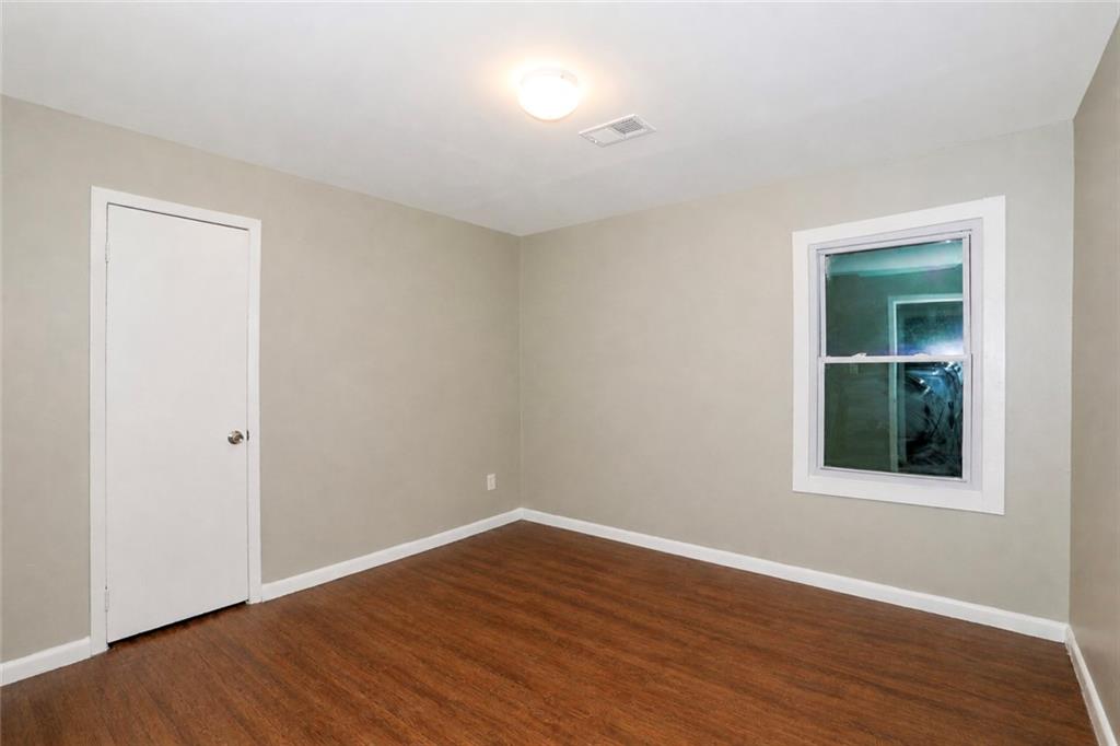 202 Wendan Way Warner Robins, GA 31093 - Photo 3 of 12 a view of an empty room with wooden floor and a window
