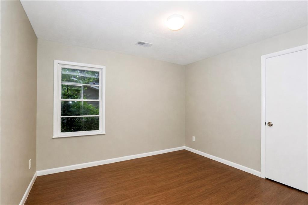 202 Wendan Way Warner Robins, GA 31093 - Photo 4 of 12 an empty room with wooden floor and windows