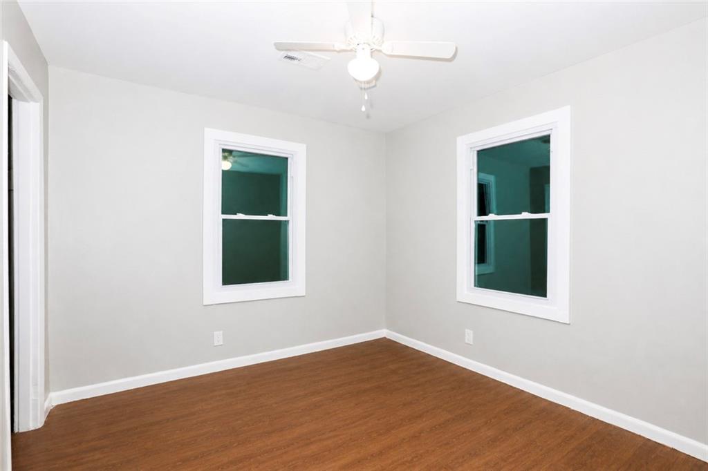 202 Wendan Way Warner Robins, GA 31093 - Photo 5 of 12 an empty room with a window and wooden floor