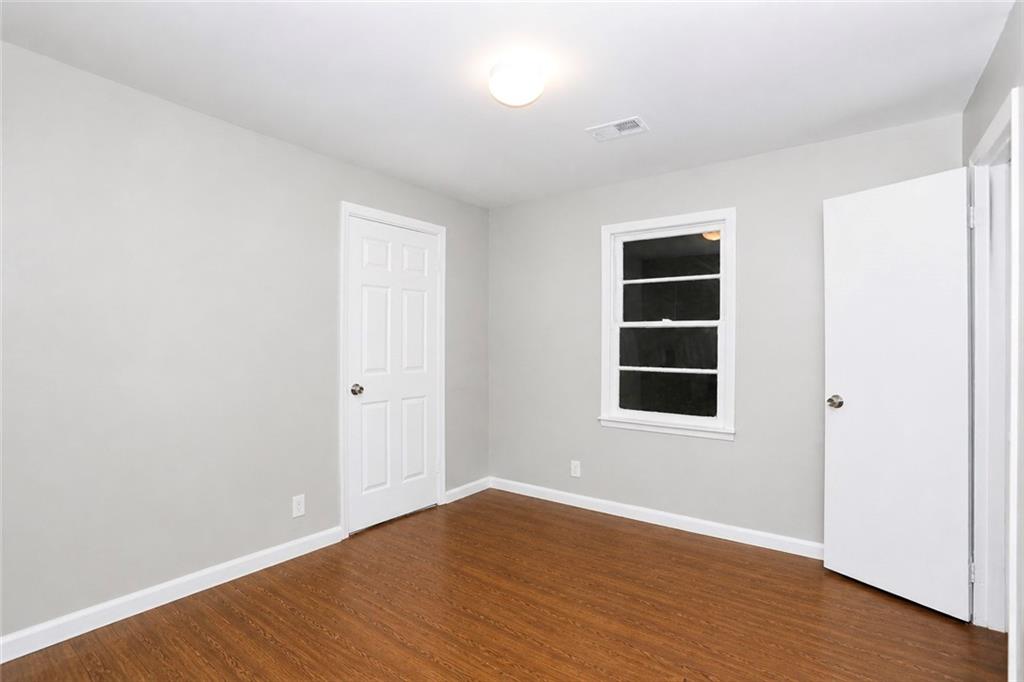 202 Wendan Way Warner Robins, GA 31093 - Photo 7 of 12 an empty room with wooden floor and window