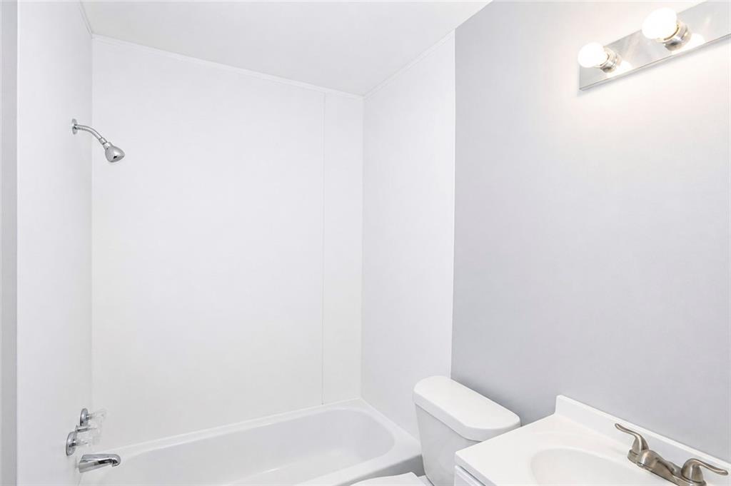 202 Wendan Way Warner Robins, GA 31093 - Photo 10 of 12 a white toilet sitting next to a bath tub