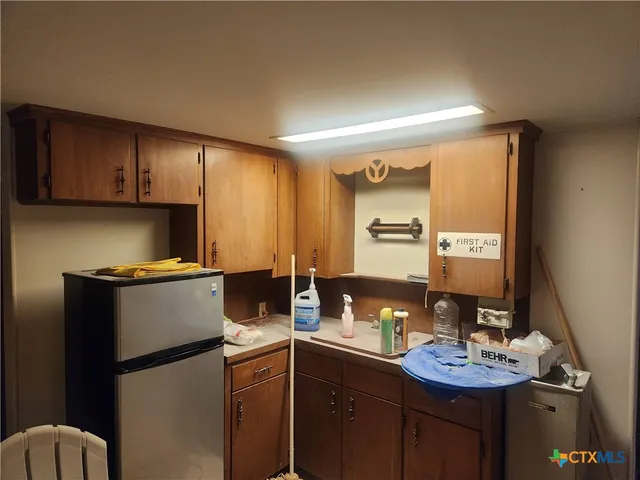 a room with a sink cabinets and wooden floor