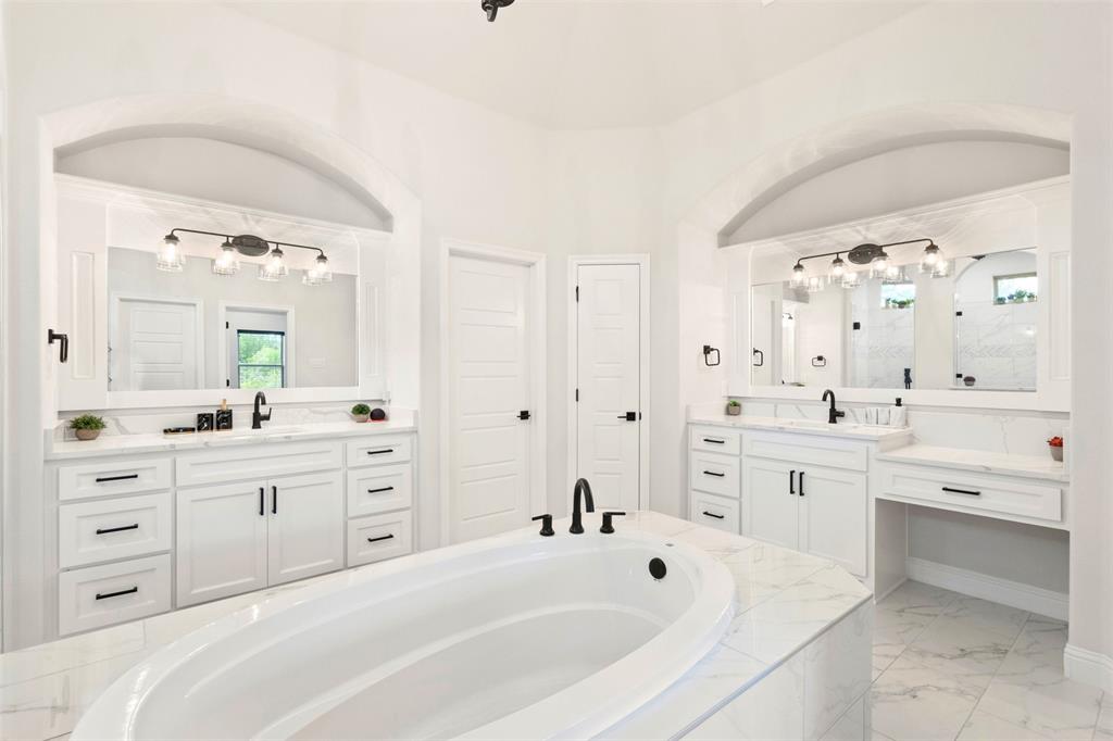 105 Clayton Crossing Springtown, TX 76082 - Photo 16 of 40 a spacious bathroom with a double vanity sink mirror and bathtub