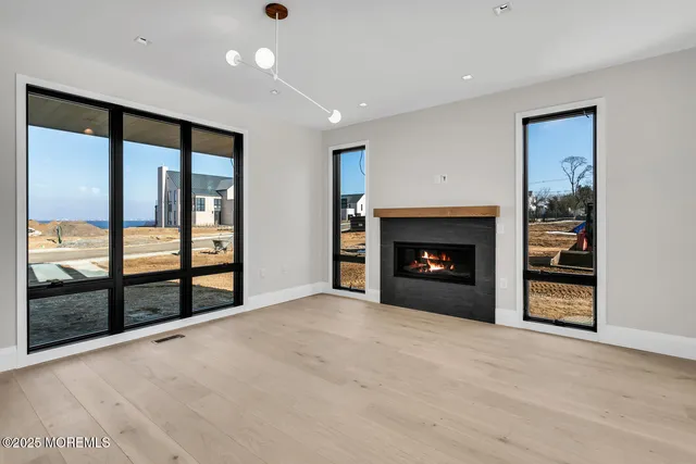 a view of an empty room with a fireplace and a window