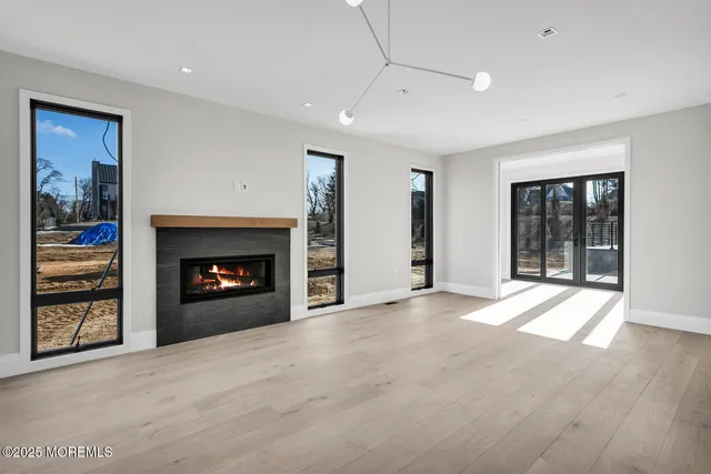 a view of an empty room with a fireplace and a window