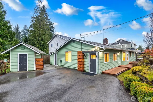 a view of a house with a yard and garage