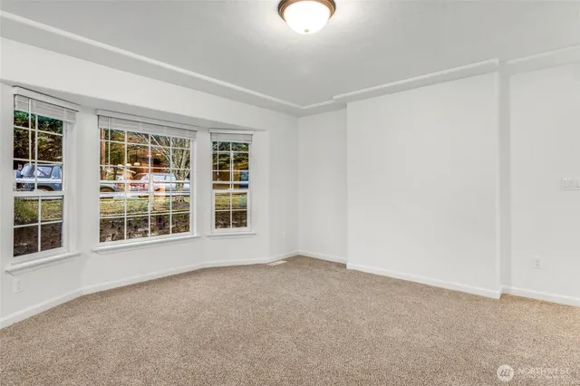 a view of a kitchen with a sink and dishwasher a stove top oven with wooden floor