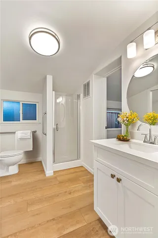 a bathroom with a granite countertop sink toilet and shower