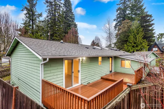 a view of a wooden chairs and table in the balcony