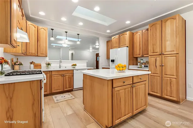 a kitchen with a sink refrigerator and cabinets