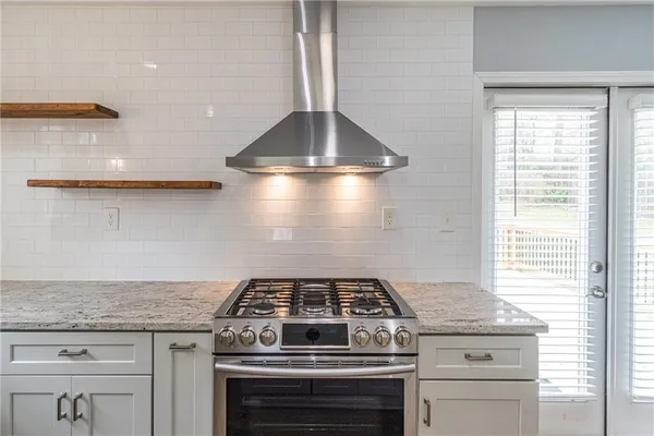 a stove top oven sitting inside of a kitchen
