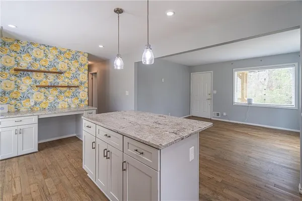 a kitchen with a wooden floor and window