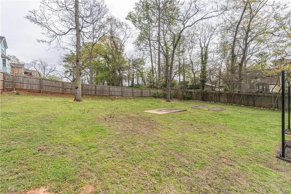 a view of a swimming pool with a yard and trees