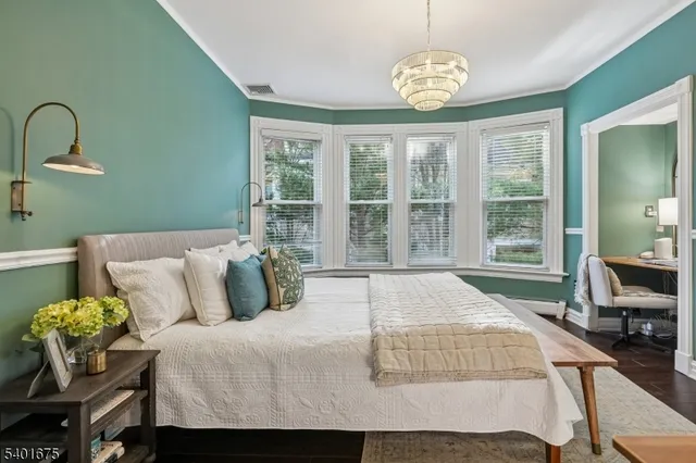 a bedroom with a bed and table chair