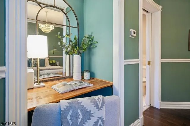 a bedroom with bed and a potted plant