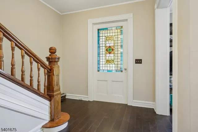 a view of an entryway with wooden floor