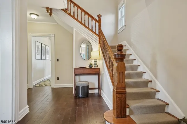 a view of entryway and hall with wooden floor