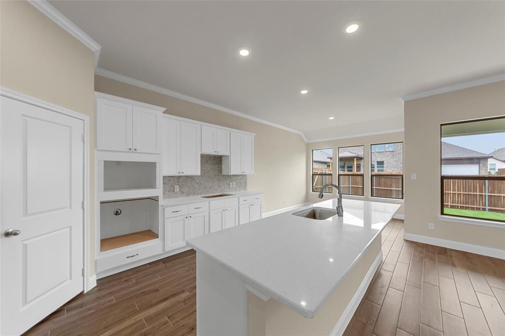 1508 Addison Lane Lancaster, TX 75134 - Photo 4 of 20 Open-concept kitchen featuring an expansive island with an undermount sink and gooseneck faucet
