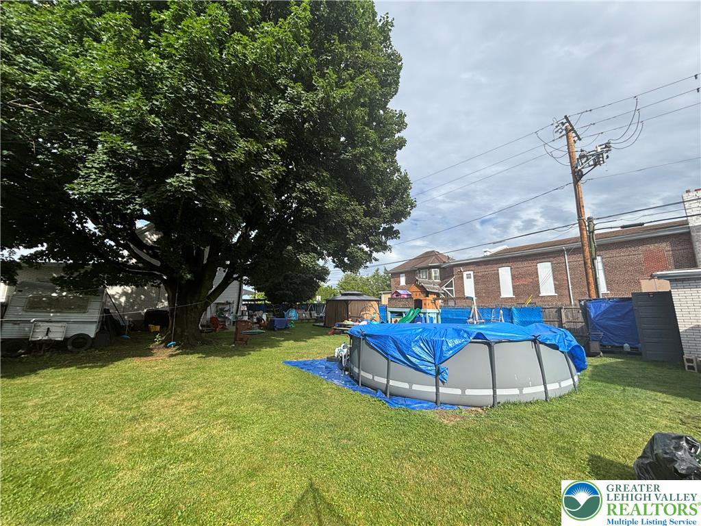 3404 North Ruch Street Whitehall, PA 18052 - Photo 34 of 36 A spacious yard offers an above-ground pool, mature trees, and ample room for outdoor activities.