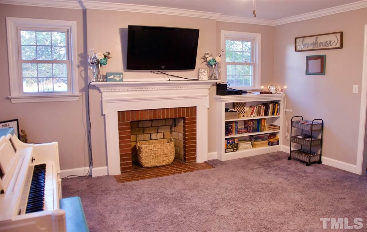 2120 Mary Hobby Road Raleigh, NC 27603 - Photo 11 of 30 a living room with a fireplace and a flat screen tv