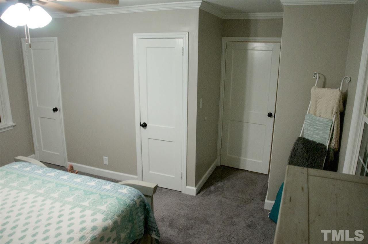 2120 Mary Hobby Road Raleigh, NC 27603 - Photo 17 of 30 a bedroom with a bed and a mirror