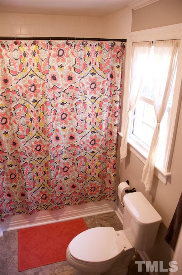 2120 Mary Hobby Road Raleigh, NC 27603 - Photo 18 of 30 a bathroom with a toilet and a shower curtain