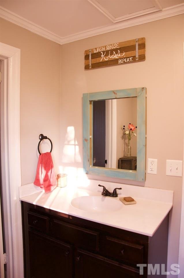 2120 Mary Hobby Road Raleigh, NC 27603 - Photo 19 of 30 a bathroom with a sink and a mirror