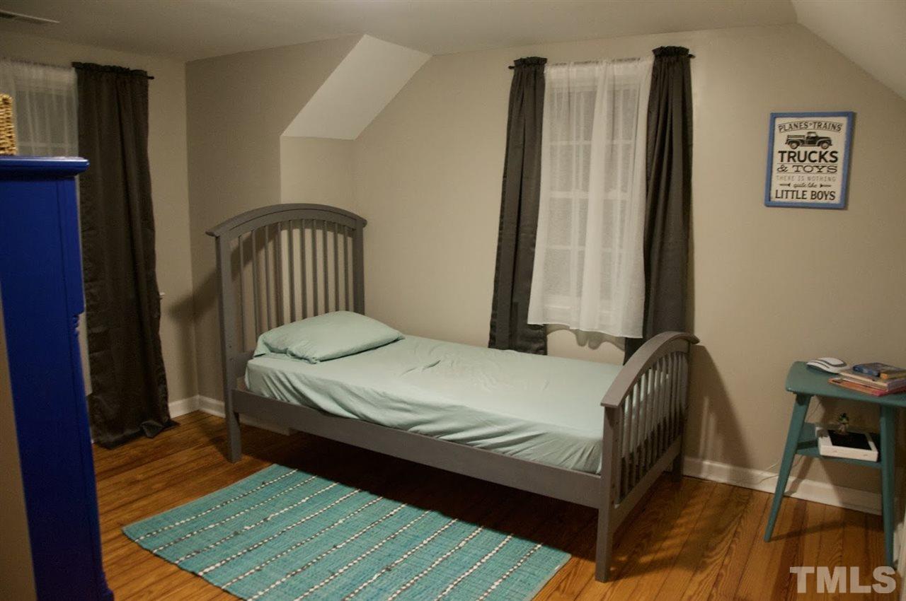 2120 Mary Hobby Road Raleigh, NC 27603 - Photo 21 of 30 a bed sitting in a bedroom next to a window